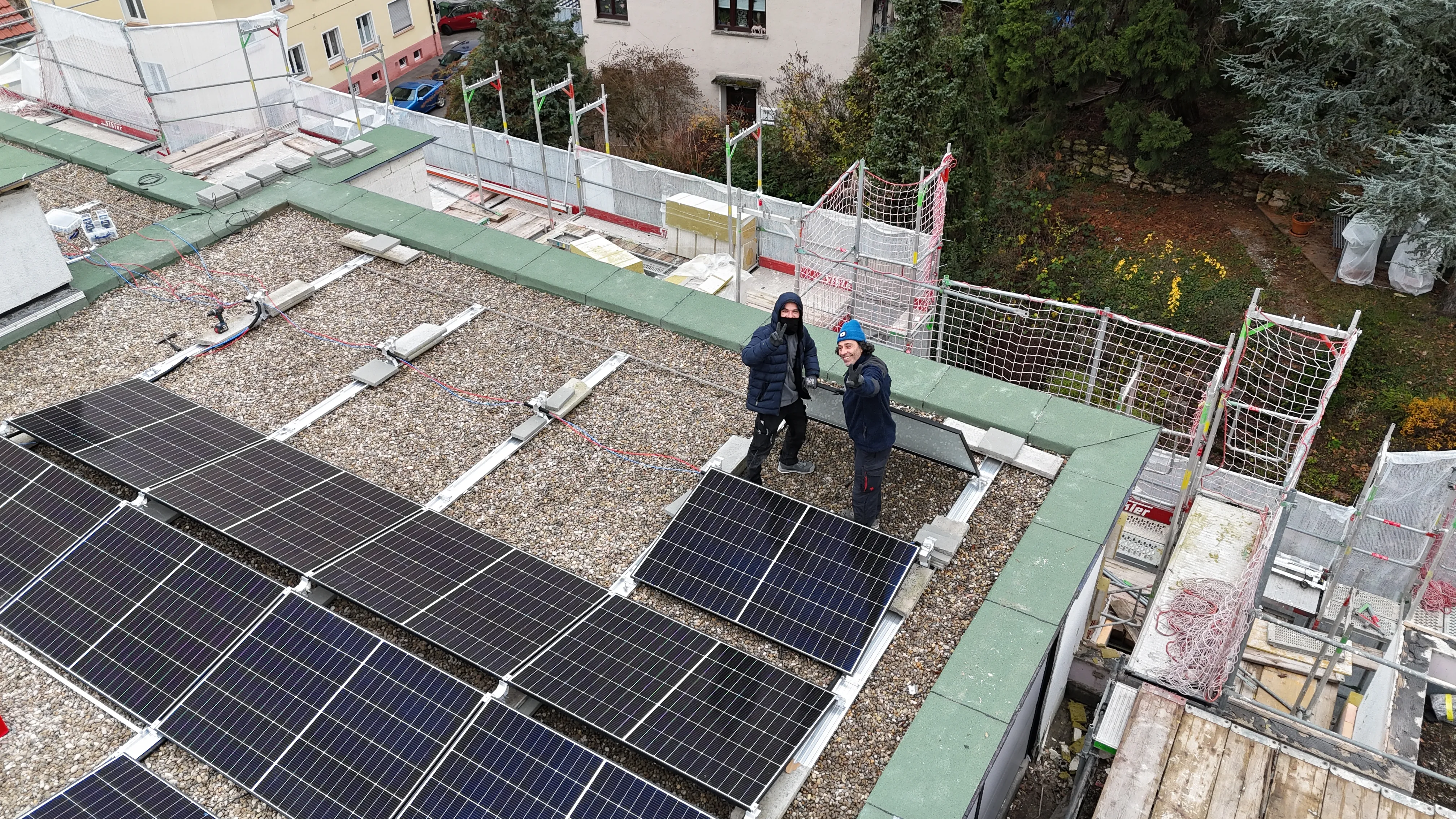 Mitarbeiter des Solarzentrum Stuttgarts bei der Montage einer Solaranlage auf einem Flachdach